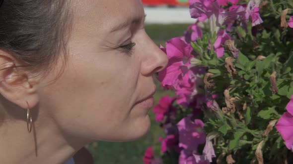 Woman at petunias.  alt