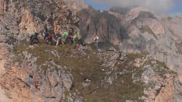 Aerial Shot of a Group of Climbers Pull the Rope alt