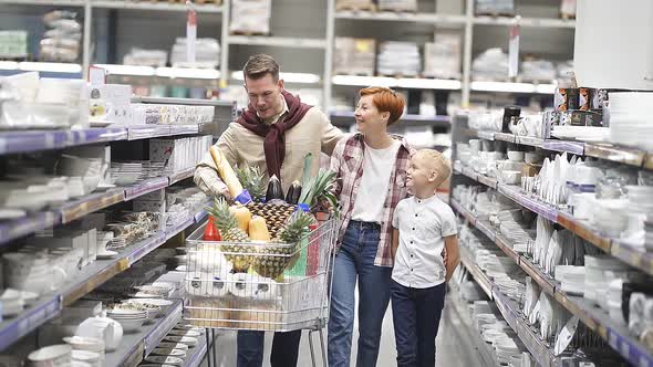 Adorable Redhead Woman And Kid Boy Look At Man Having Conversation During Shopping