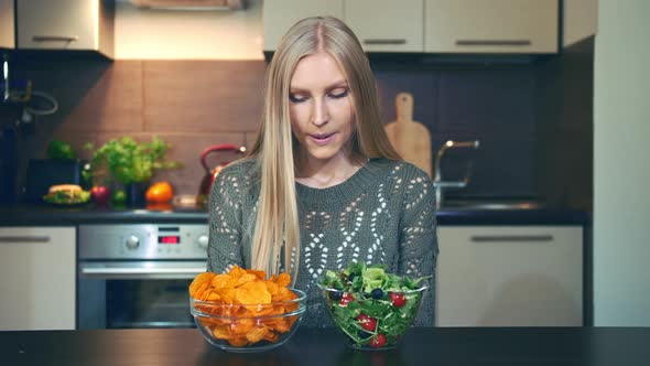 Young Woman Preferring Salad To Crisp alt