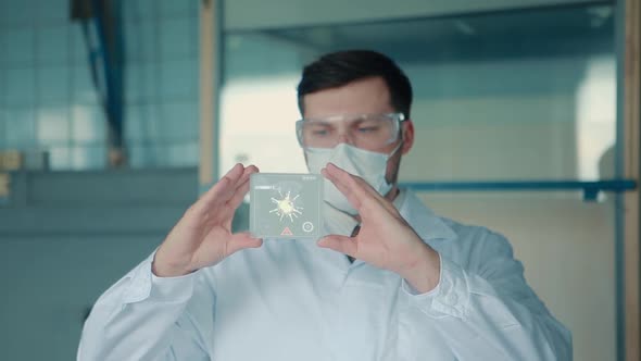 A doctor in a protective mask holds in his hands a virtual medical glass for analysis