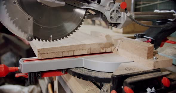 Slow Motion Close Up the Master Cuts a Wooden Board with a Circular Saw in the Woodworking Workshop alt