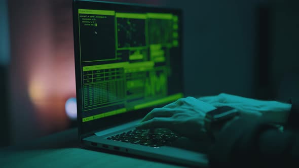 Hacker is Working on Laptop at Night