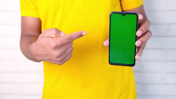 Close Up of Young Man Hand Using Smart Phone with Green Screen alt