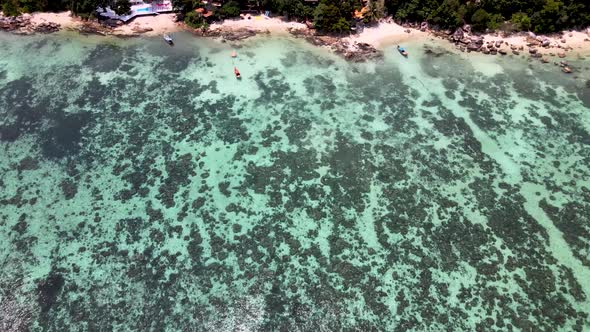 Overhead Aerial Over Tranquil Coral Waters Towards Beach At Koh Lipe. Dolly Dolly Forward alt