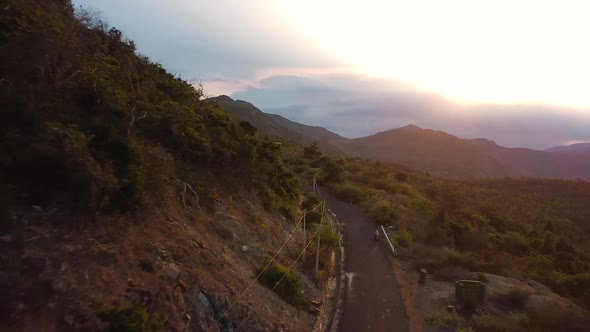 Aerial Scenic View at Sunset on a Road in the Mountainous Area of Asia. alt