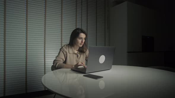 Businesswoman working late hours with her laptop