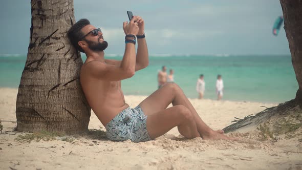 Selfie On Smartphone In Beautiful Place. Man Using Mobile Phone For Selfie Photo. Mobile App. alt