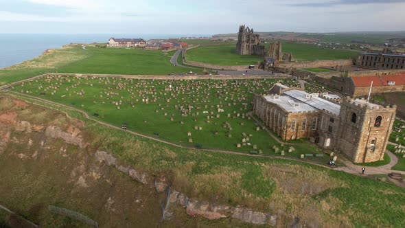 Aerial View Of St Mary's Church With Cemetery And Whitby Abbey In North Yorkshire, England, UK. alt