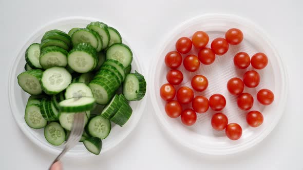 Man on Diet Eats Chili Tomato and Cucumber From Plate alt