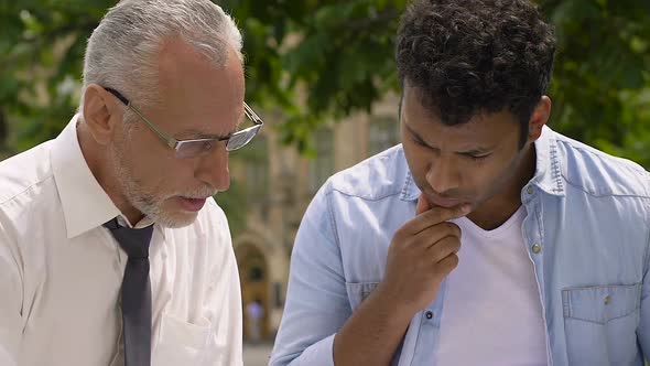 Instructor helping student to understand complicated problems and formulas alt