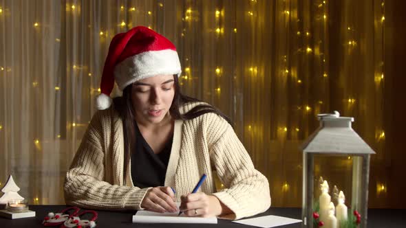 Pretty Woman Writing Letter at Christmas Time