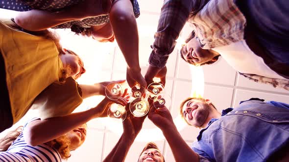 Creative business team toasting glasses of champagne alt