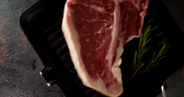 Steak Beef Raw T-bone on a Frying Pan Put on the Table.  alt