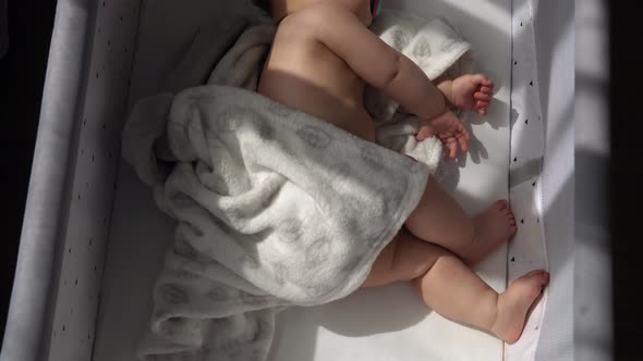 Top View Face of Newborn Nnaked Sleeping Little Small Infant Baby Boy Lying On Side On Soft White alt