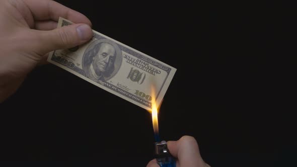 Incineration Of $ 100 Bills On A Black Background. Slow Mo_01