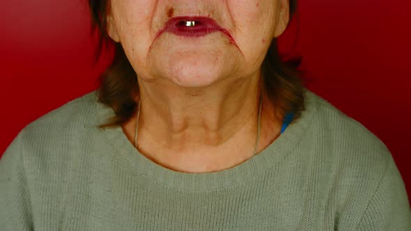 Part of Elderly Woman's Face on Red Background alt