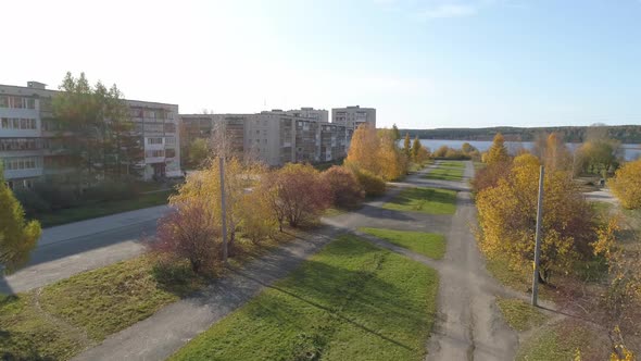 Drone view of park with trees in provincial city with soviet panel houses 34 alt
