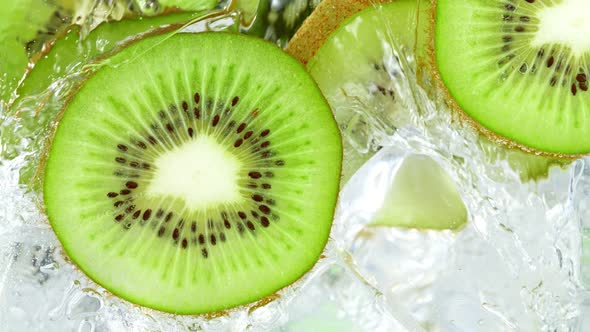 Super Slow Motion Shot of Pouring Water on Sliced Kiwi and Ice Cubes in Glass at 1000 Fps alt