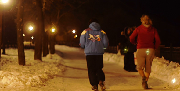 People Running In Winter Night