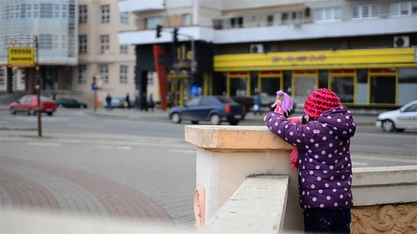 Girl Playing With Dolls Near Car Traffic