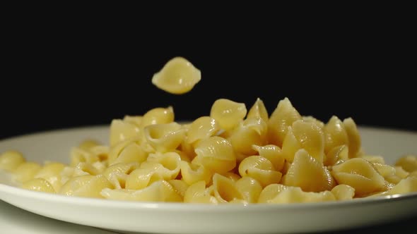 SLOW MOTION: Cooked Conchiglie Fall Into Full Plate alt