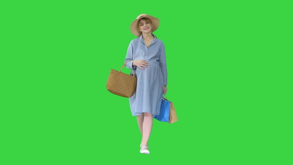 Pregnant Woman in Summer Clothes Walking with Shopping Bags on a Green Screen Chroma Key alt