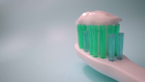 Extreme Macro Video Filming Toothbrush on a Blue Background in Motion Toothpaste on the Brush alt