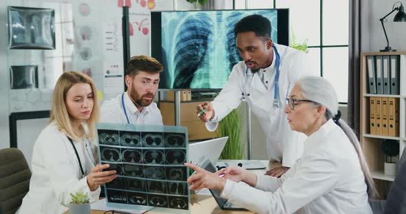 Doctors Consulting About Methods of Patient's Treatment Using Results of Chest X-ray Scan alt
