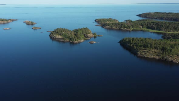 Aerial view on the lake and Islands with rocky coastline and forest in Karelia