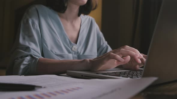 Close up of business woman work overtime in living room at late night due to Covid 19 pandemic. alt