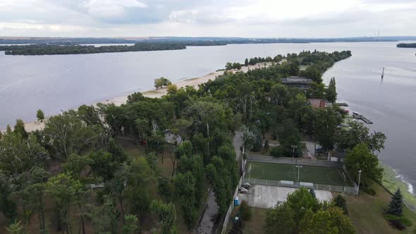 A Sparsely Populated White Sand Beach Surrounded By Trees and Clear Waters of the Dnieper River