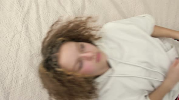 Upset Teenage Girl Falling on Bed
