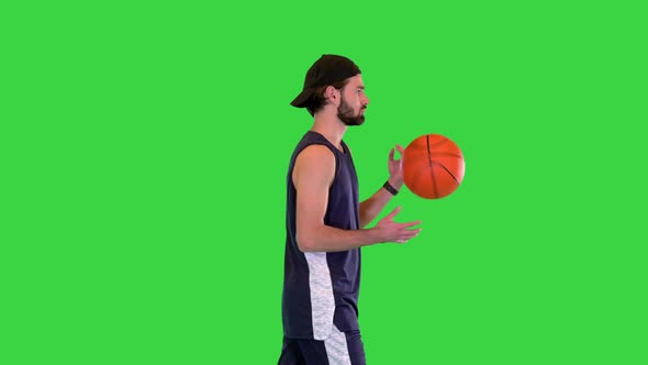 Basketball Player Walking with Ball in Hands on a Green Screen Chroma Key