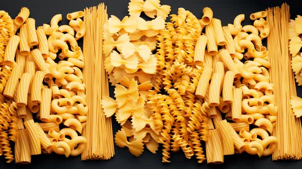 Pile of arranged raw different kinds of pasta. Seamlessly looping animation. alt