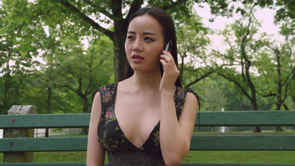 Girl Talking On Cell Phone In The Park