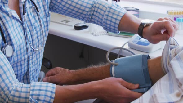 Doctor examining a senior man in a retirement home alt