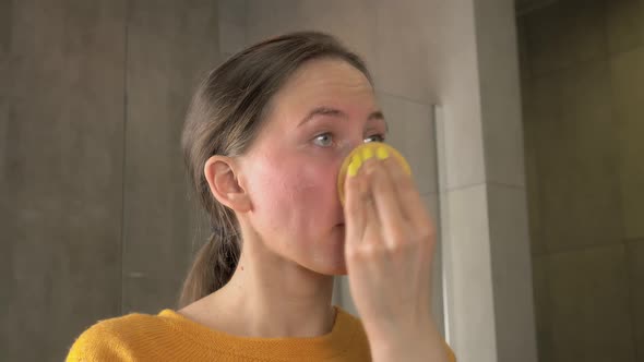 Young woman washes off removes makeup before bedtime skin care routine alt