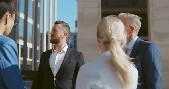 Successful Business Colleagues Discussing Project Outside alt