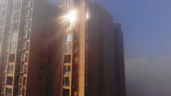 Building with Rays of Sunlight Coming Out of Windows in the Clouds
