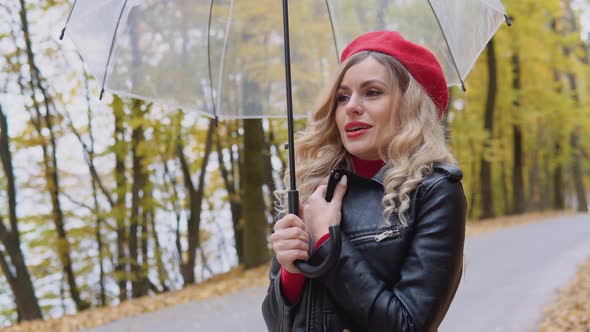 Beautiful Young Woman Coughs Standing By an Umbrella on a Cold Autumn Day alt