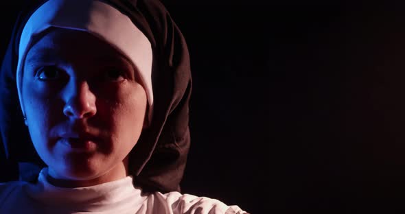 Nun Praying In The Dark