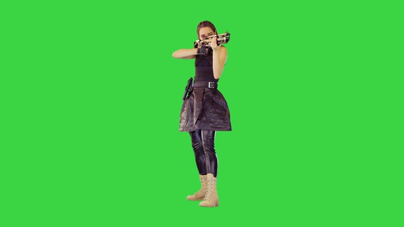 Girl with a Gun Searches for Aim and Makes a Single Shot on a Green Screen Chroma Key