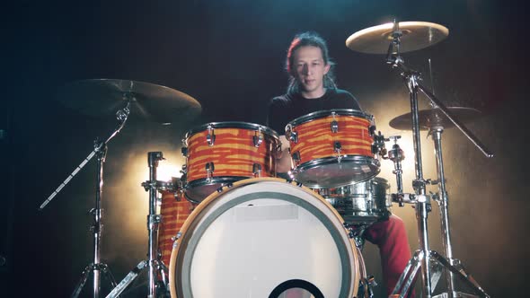 A Man Is Enjoying Playing the Drums in a Studio alt