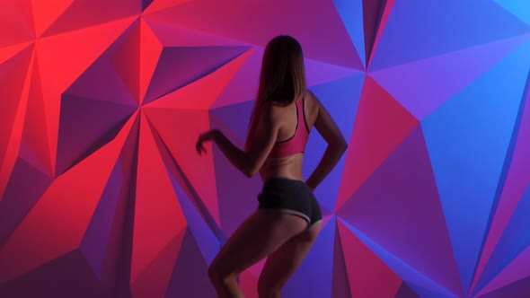 Girl Dancing Energetic Dance Booty in Shorts on Bright Graphic Background alt