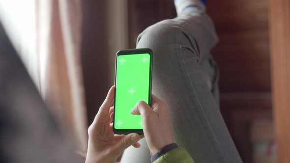 Young Woman at Home Lyung and Use Smartphone with Green Screen