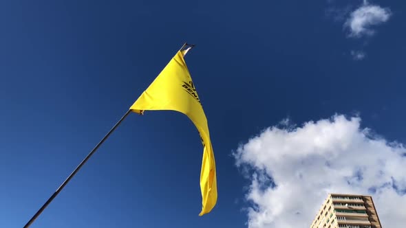 Yellow Benidorm beach SOS flag slow motion footage blowing in the wind