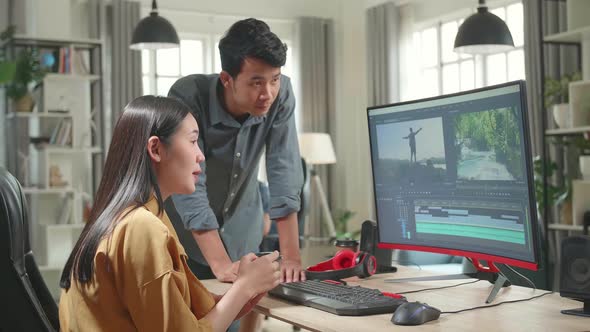 Female Video And Sound Editor Works With Her Male Colleague On A Project On Her Personal Computer alt