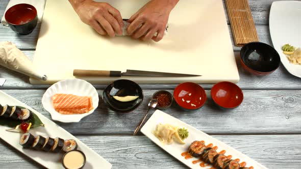 Man's Hands Cook Sushi. alt