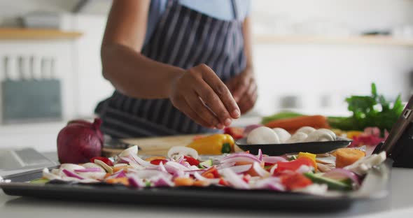 Happy african american woman preparing dinner in kitchen alt